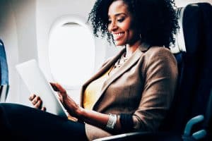 woman using tablet on airplane